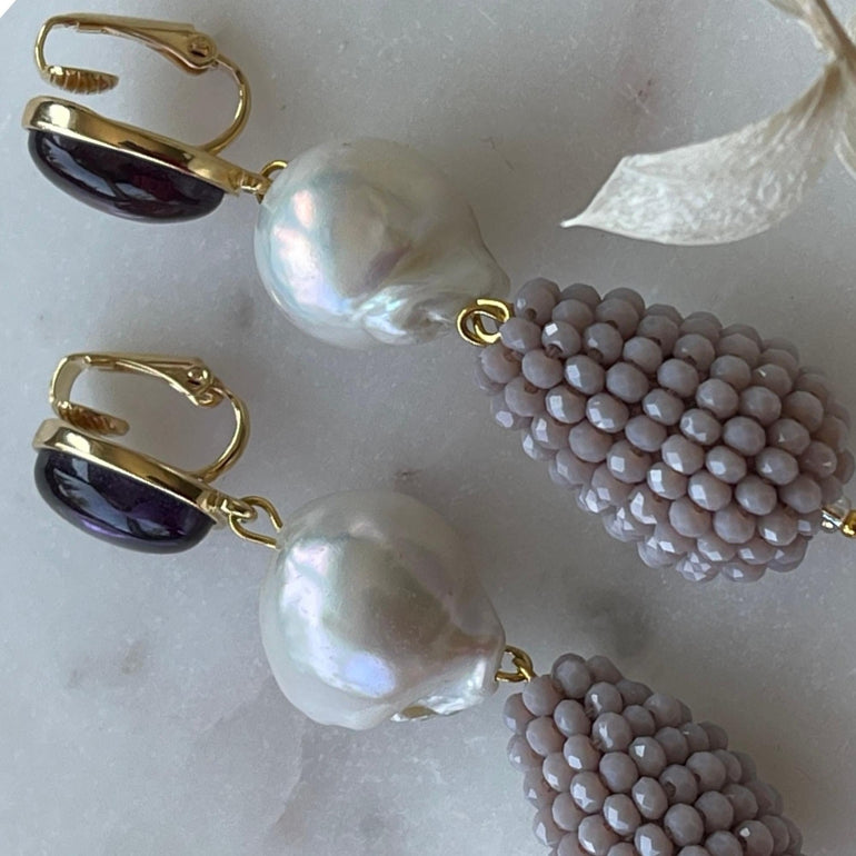 Lila Ohrclips CHARLOTTE: Amethist, Barrockperlen und Kristalle. Länge: 7,0 cm. Verstellbarer Clip-Verschluss für optimalen Tragekomfort. Ein vielseitiger Ohrring mit brasilianischem Amethyst, Barrockperlen und funkelnden Kristallen. Perfekt für formelle Anlässe und lässige Veranstaltungen, verleiht er Ihrem Look Klasse und Stil